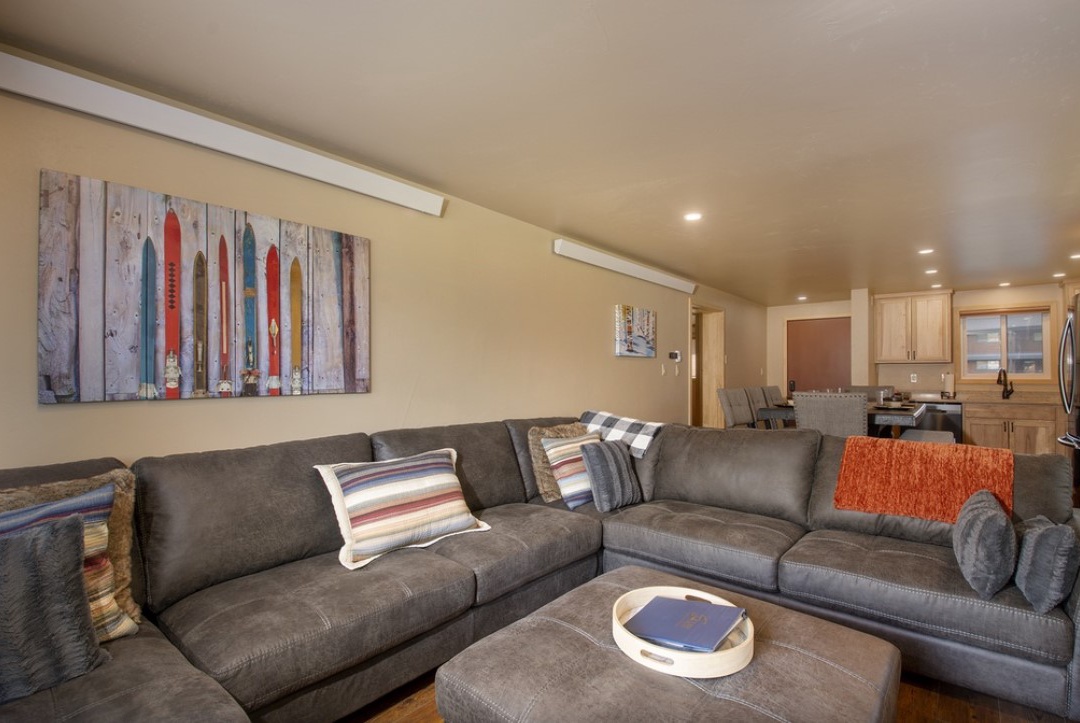Sink into plush sectional seating where your group can unwind together, with colorful ski artwork creating perfect mountain vibes.