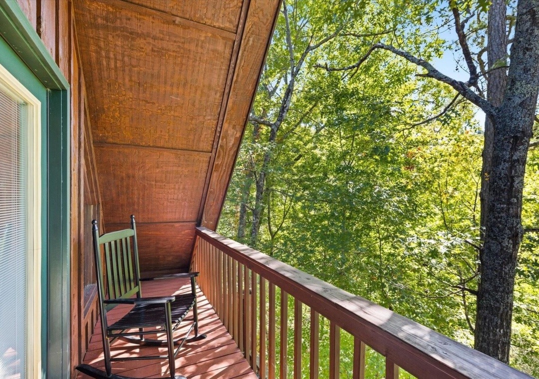 Step onto your private balcony and breathe in the fresh forest air as you rock gently in the peaceful chair.