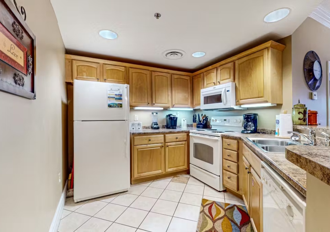 Your fully equipped kitchen features warm wood cabinets, granite counters, and everything you need to create memorable meals together.