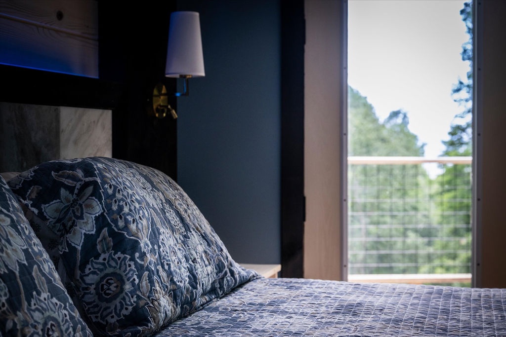 Wake up to serene treetop views framed by your private balcony. Sink into plush linens and let natural light fill your peaceful retreat.