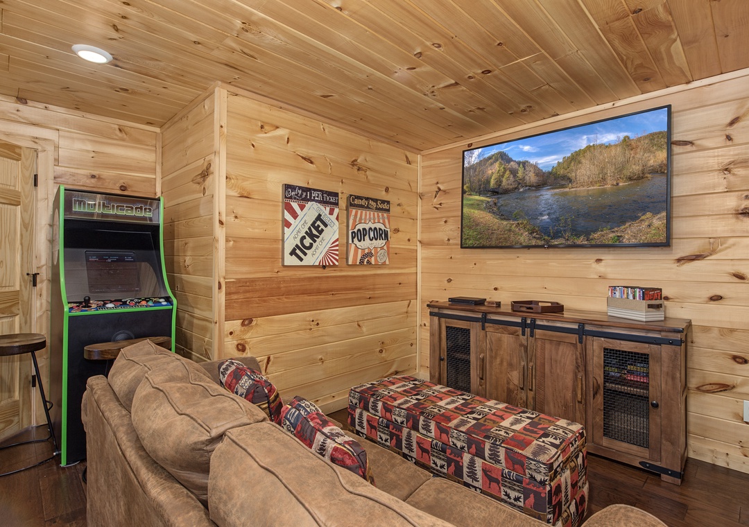 Unwind in your own cozy game room, where rustic wood paneling wraps you in cabin comfort. Sink into the plush sofa, challenge friends to arcade classics, and enjoy your favorite shows on the large screen.