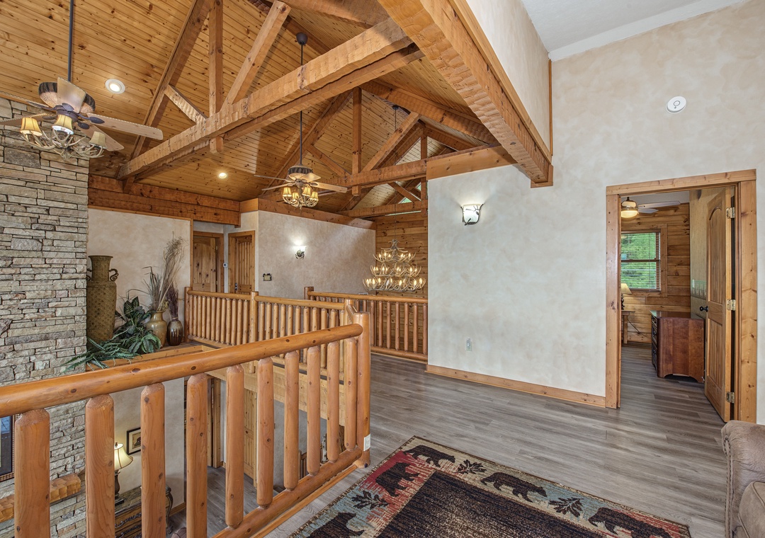 Stunning exposed beam architecture and warm wood accents welcome you into this inviting cabin retreat, where rustic elegance meets modern comfort throughout your stay.