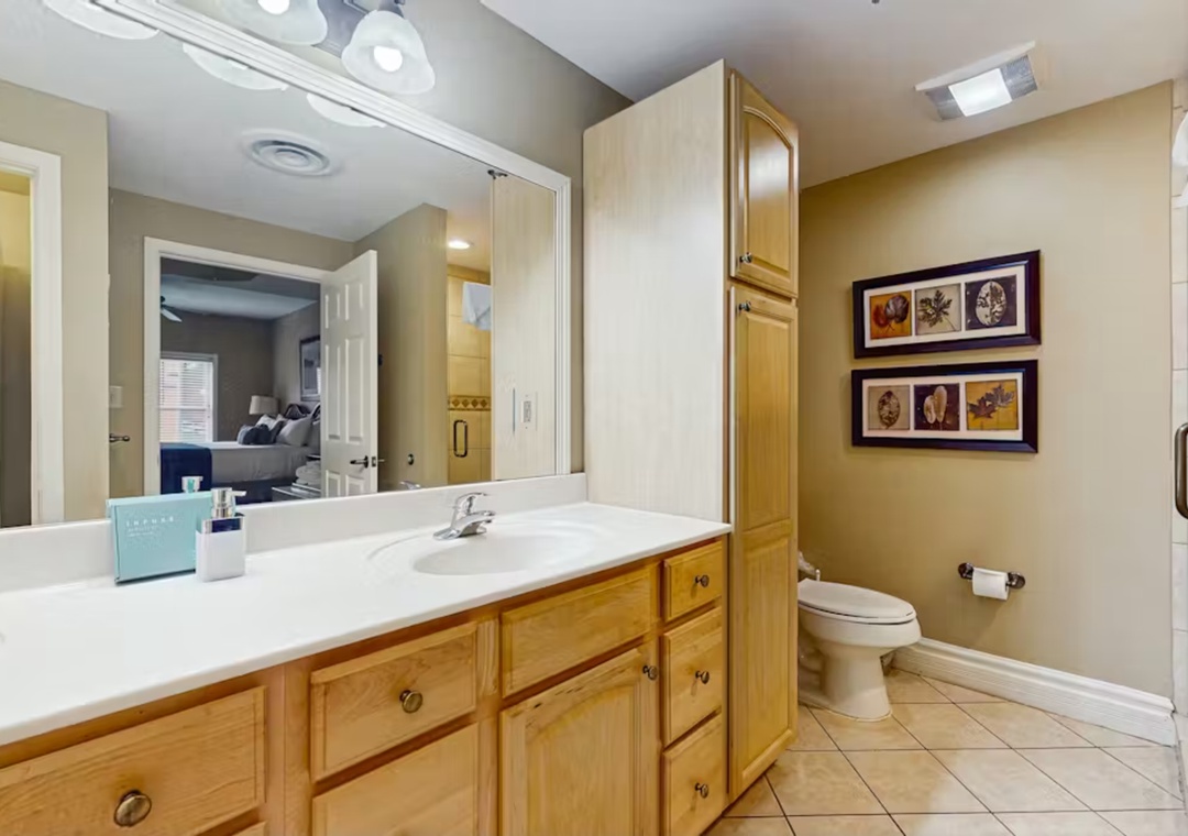 Refresh in your spacious bathroom featuring warm wood cabinetry, ample counter space, and thoughtful design touches that make your daily routine feel luxurious.