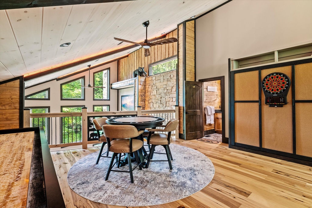Challenge your group to a game at the sleek poker table or test your aim at the electronic dartboard in this bright, open game space with soaring ceilings and beautiful forest views.