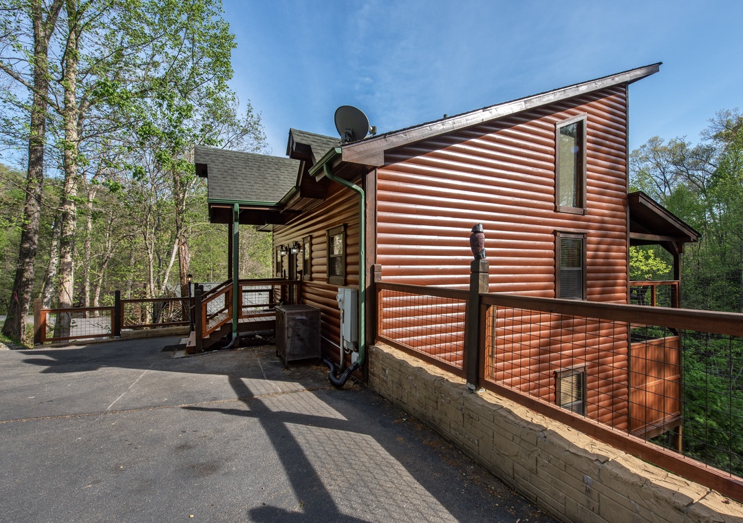 Modern log cabin nestled in wooded surroundings with convenient parking and scenic forest views.