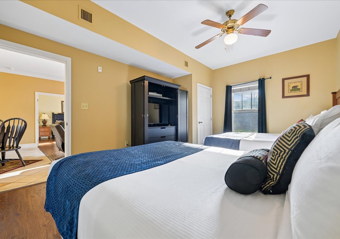 Sink into your cozy bedroom sanctuary, where twin beds await beneath a gentle ceiling fan. Wake refreshed with natural light streaming through your windows.