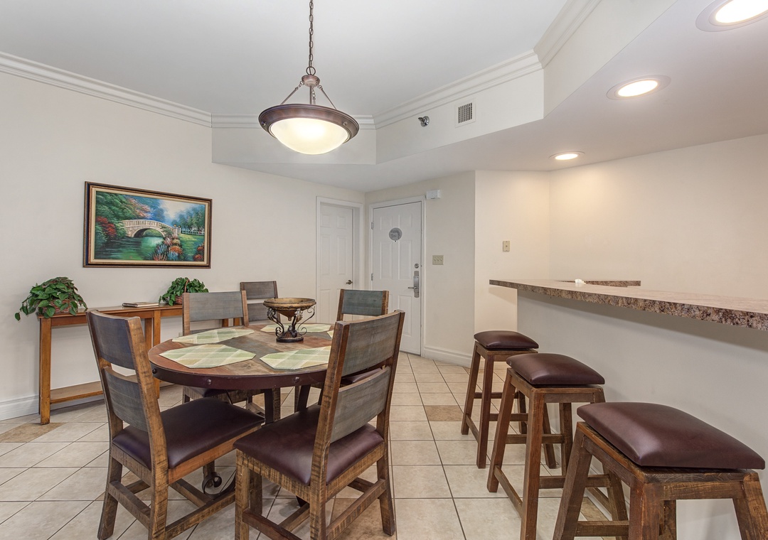 Gather around this elegant dining space where warm wood tones and leather seating create the perfect spot for your vacation meals.