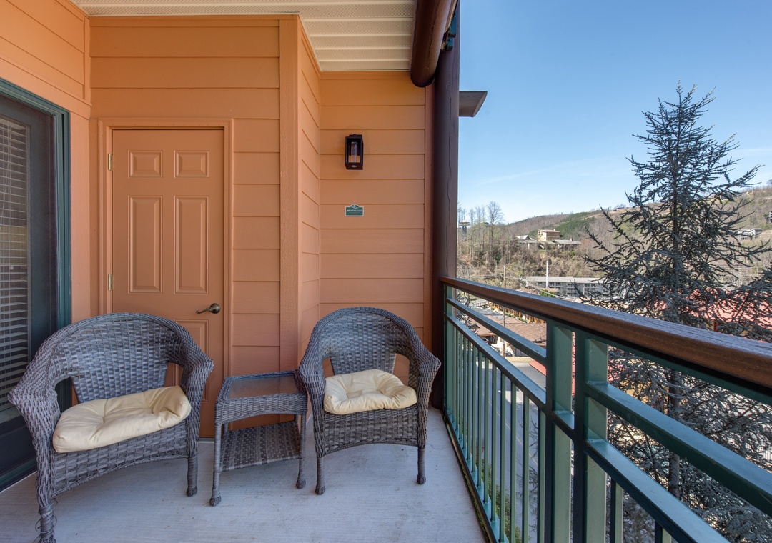 Step onto your private balcony to unwind in cozy wicker chairs while taking in peaceful mountain views.