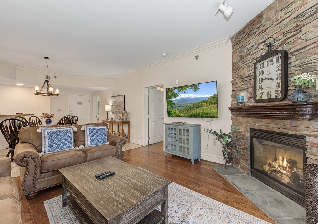 Cozy up by your crackling stone fireplace while watching your favorite shows, with comfortable seating and rustic charm throughout.