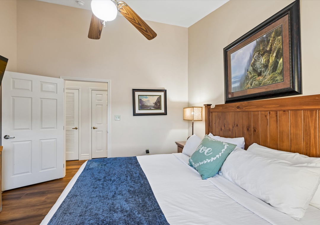 Drift off to sleep under the gentle hum of your ceiling fan, surrounded by warm wood accents and mountain artwork.