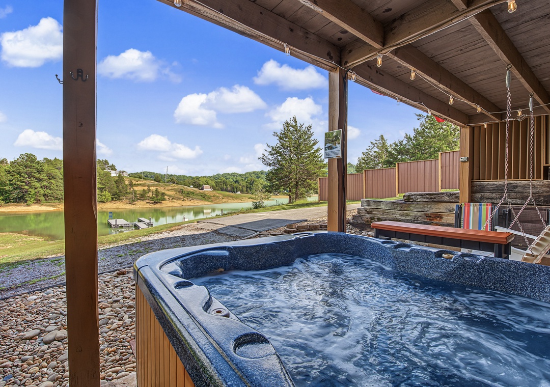 Soak in your private hot tub while taking in serene views of the lake and rolling hills. The covered patio keeps you comfortable, and a porch swing invites quiet moments of relaxation.