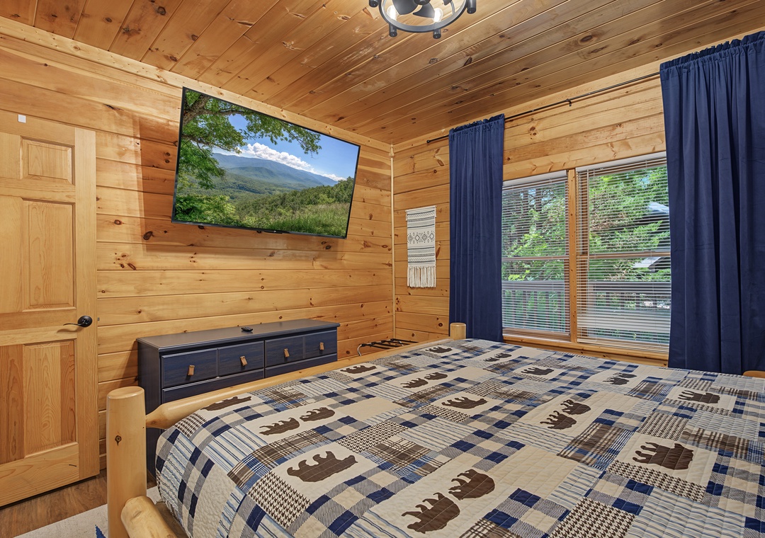 Wake up surrounded by warm pine walls in your cozy bedroom. Watch the large TV or gaze through the windows at the trees beyond, enjoying peaceful mountain views from your private retreat.