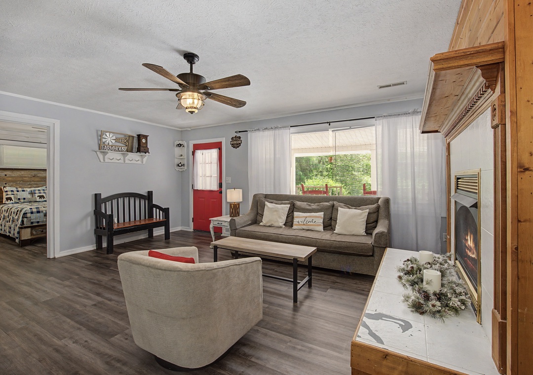 Relax in your cozy living space with plush seating, warm fireplace, and charming rustic touches that make this feel like home.