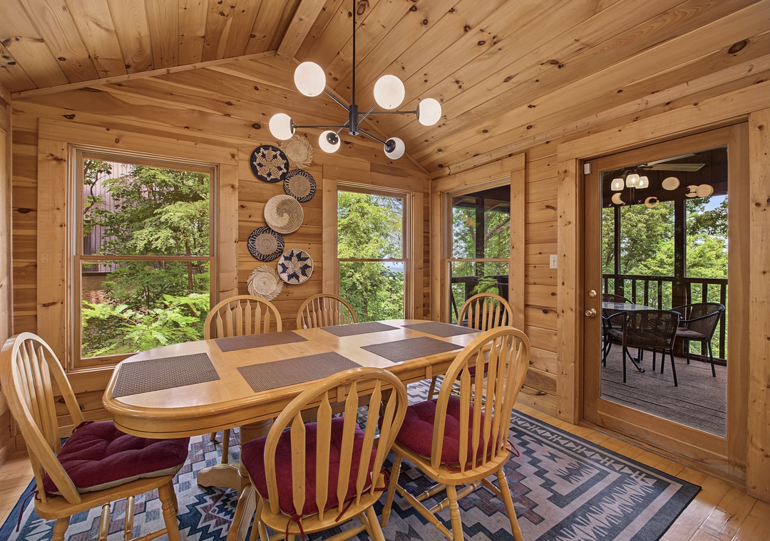 Gather around this warm, inviting dining space with its rustic wood-planked walls and ceiling, where your group can enjoy meals together. Step outside through the adjacent doors to your private deck for morning coffee or evening relaxation.