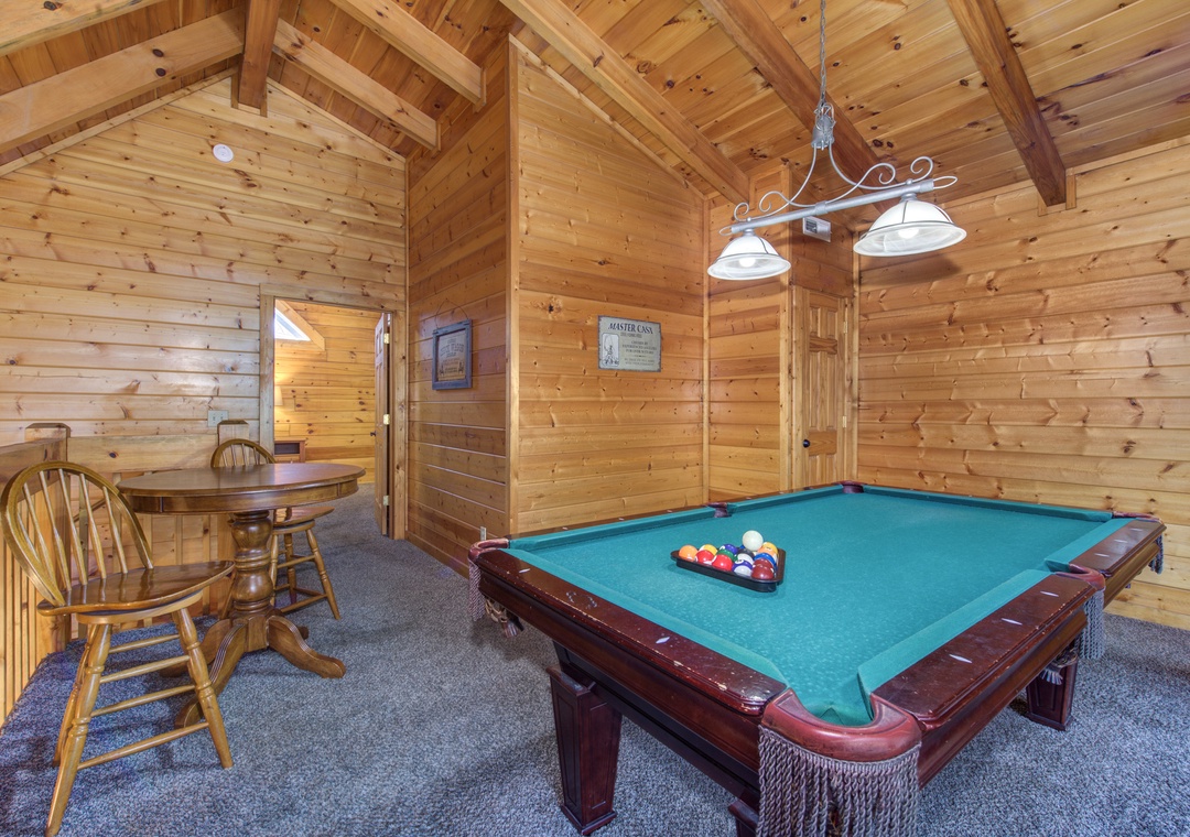 Challenge friends to pool while enjoying the rustic charm of exposed wood beams and warm cabin atmosphere in your private game room.
