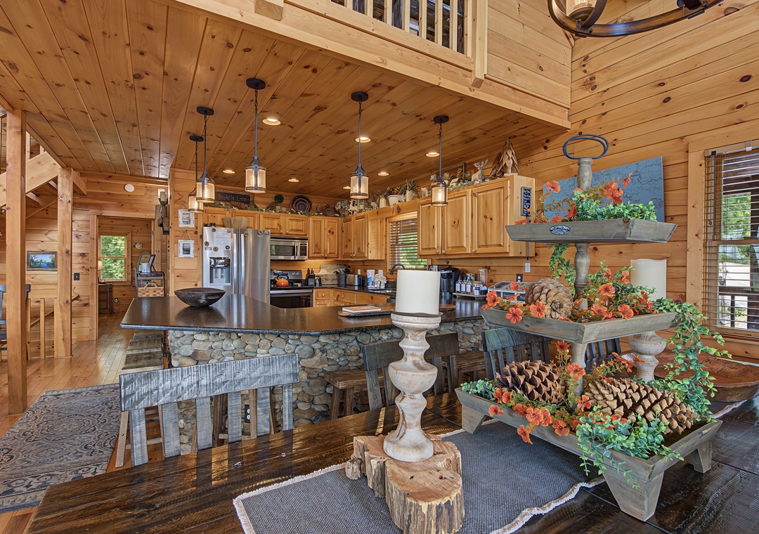 Step into a beautifully crafted cabin where warm knotty pine walls, rustic stone accents, and cozy pendant lighting create your perfect mountain retreat. Enjoy cooking in your fully equipped kitchen and gathering at the unique dining table.