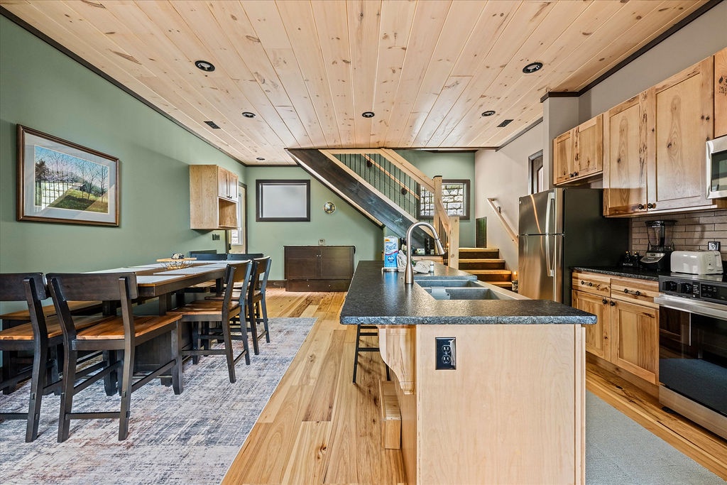 Warm wood tones and modern touches create your perfect mountain retreat. Gather around the spacious island, share meals at the dining table, and feel at home in this inviting open-concept space.