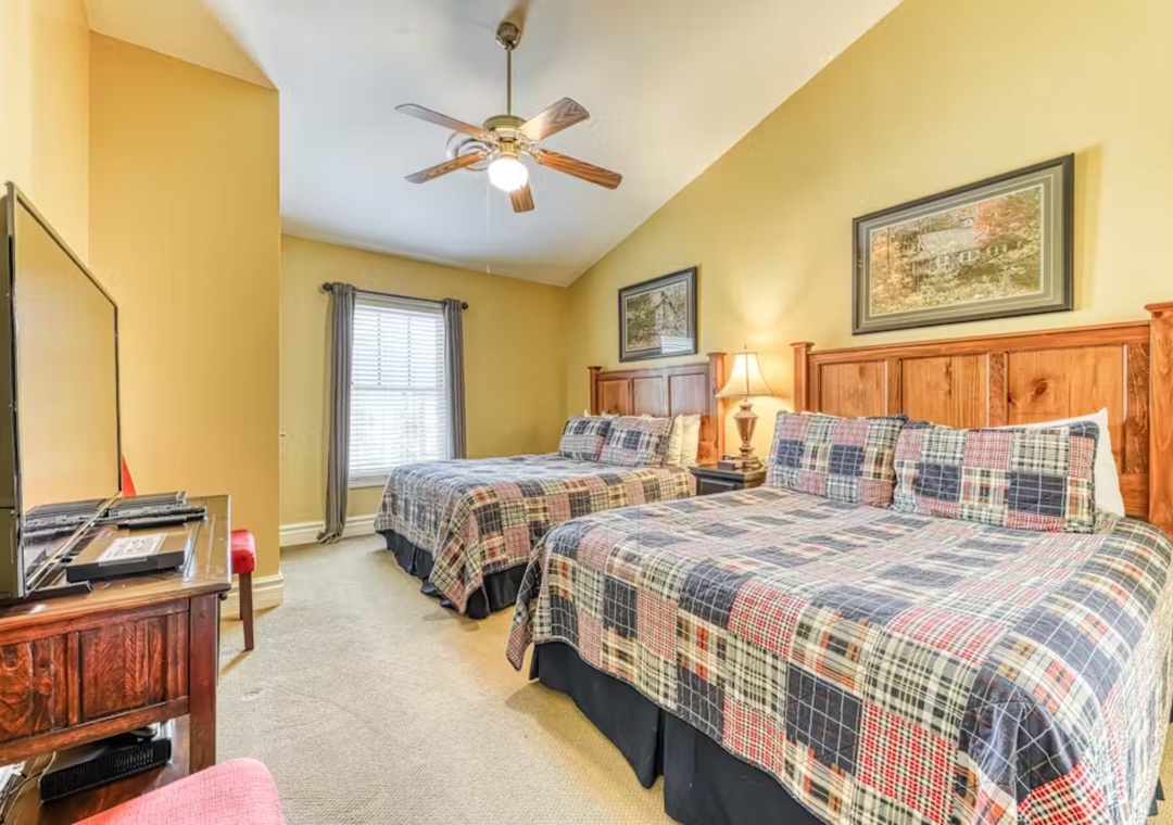 Relax in your cozy twin bedroom with plaid quilts, warm lighting, and rustic charm perfect for peaceful nights.