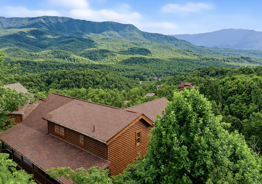 Mountain retreat surrounded by lush forest and rolling peaks, offering a serene escape in nature's beauty with panoramic views of the scenic landscape.