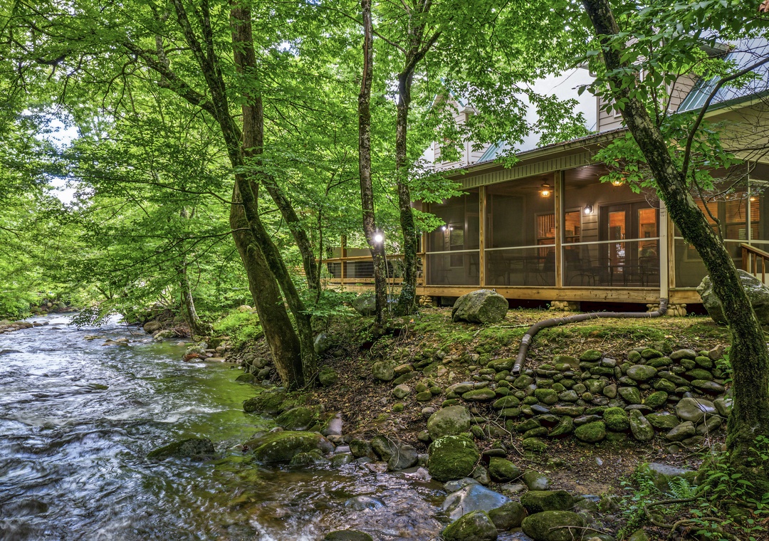 Nestled beside a tranquil creek, this charming retreat offers a peaceful escape surrounded by lush forest and the soothing sounds of flowing water.