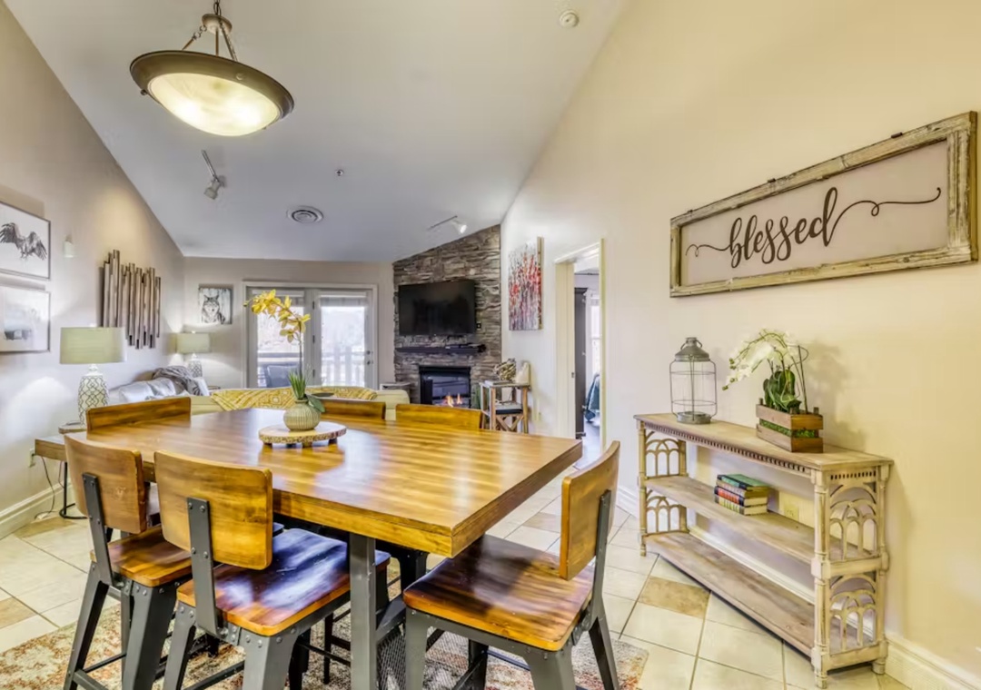 Gather around your warm dining table where rustic charm meets modern comfort, creating perfect moments for shared meals and conversation.