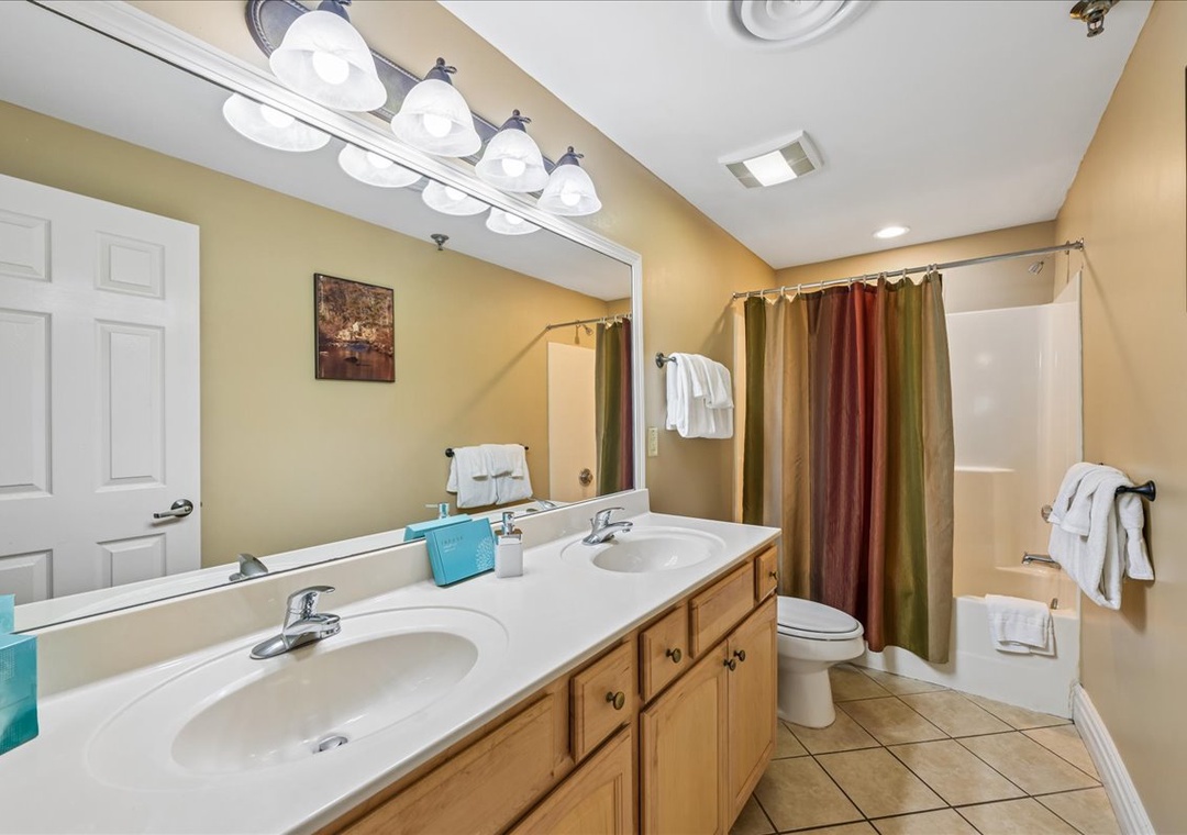 Relax in your spacious bathroom with dual vanities, perfect lighting, and a soothing tub-shower combo after your adventures.