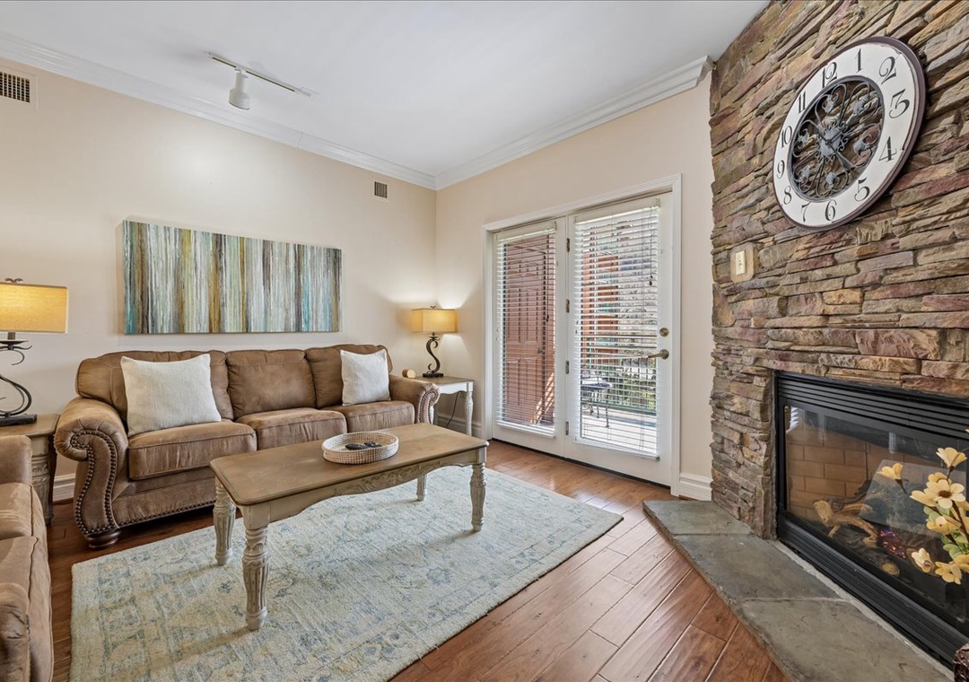 Unwind in your cozy living room with a crackling fireplace, plush sofa, and warm lighting creating the perfect atmosphere for relaxation.