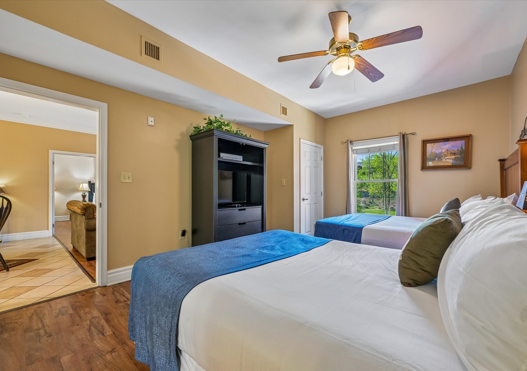 Rest in comfort with two beds, your own TV, and a peaceful ceiling fan to keep you cool and relaxed.