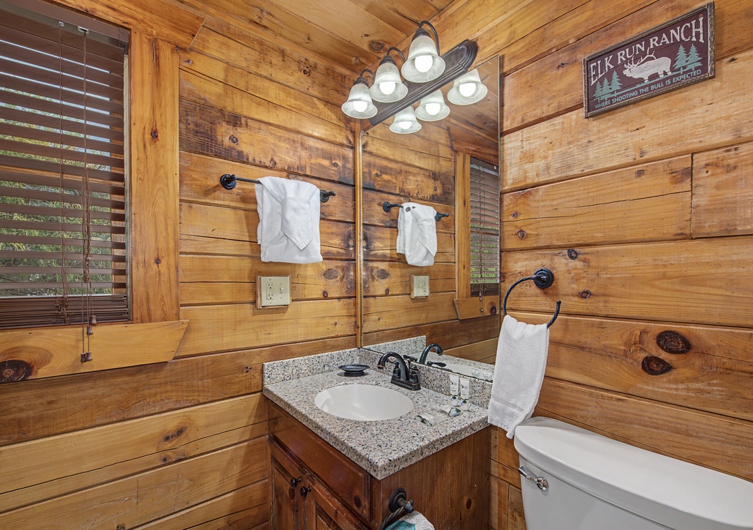 Step into your rustic bathroom where warm wood surrounds you and fresh towels await your mountain getaway moments.
