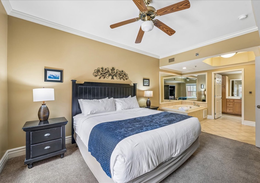 Sink into crisp linens and unwind beneath your ceiling fan's gentle breeze in this spacious retreat.