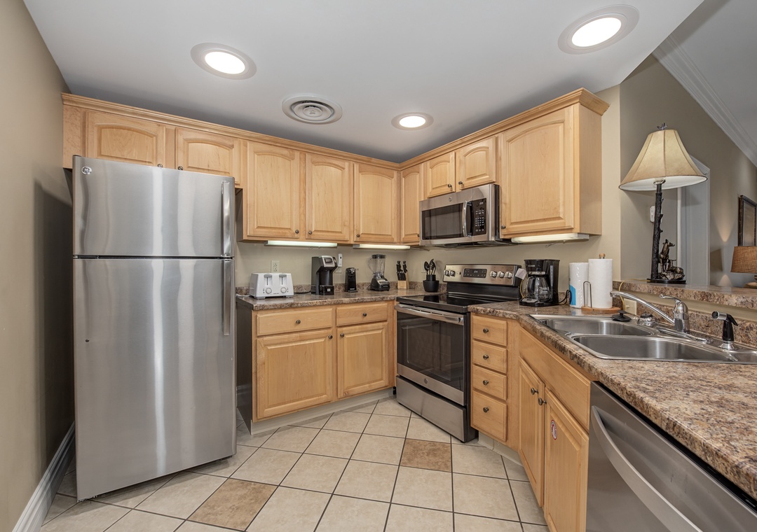 Cook your favorite meals in this fully equipped kitchen with granite counters, stainless steel appliances, and ample storage space.