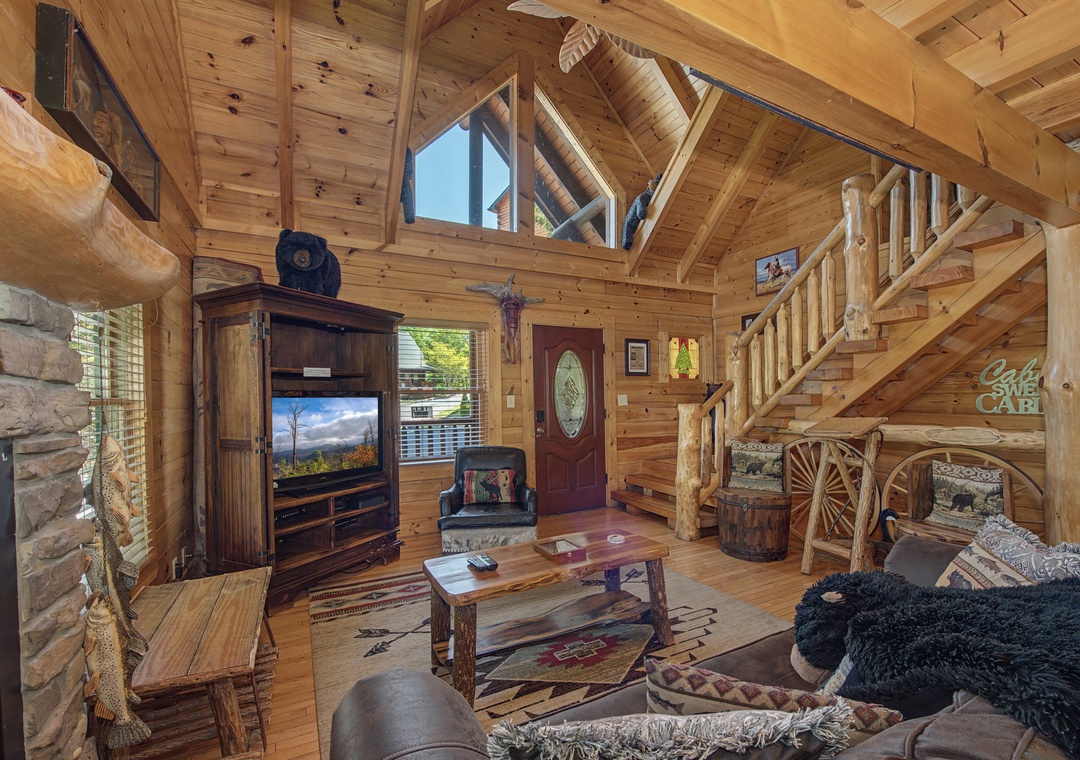 Step into your rustic retreat where soaring log beams, cozy fireplace, and handcrafted furnishings create the perfect mountain getaway atmosphere.