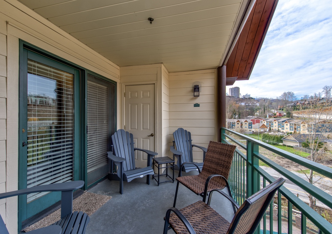 Unwind on your private balcony with comfortable seating and peaceful neighborhood views stretching beyond.