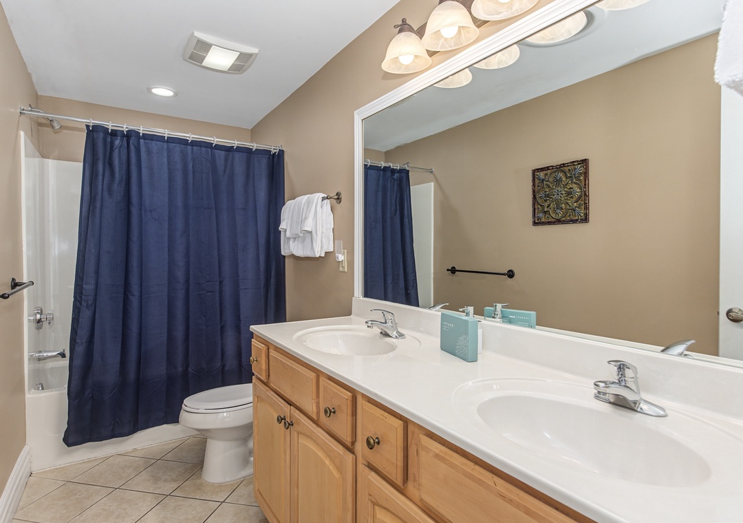 Freshen up in your spacious bathroom with dual sinks and a relaxing tub-shower combo for ultimate comfort.