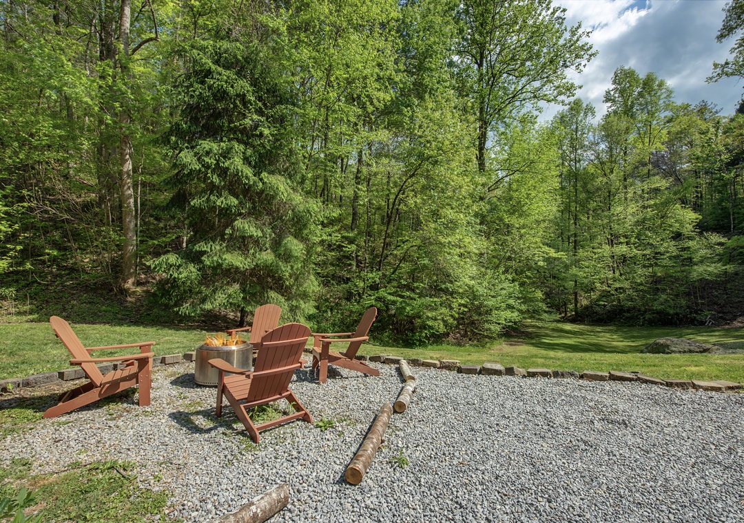 Gather around the crackling fire pit with cozy Adirondack chairs, surrounded by towering trees and peaceful forest views.