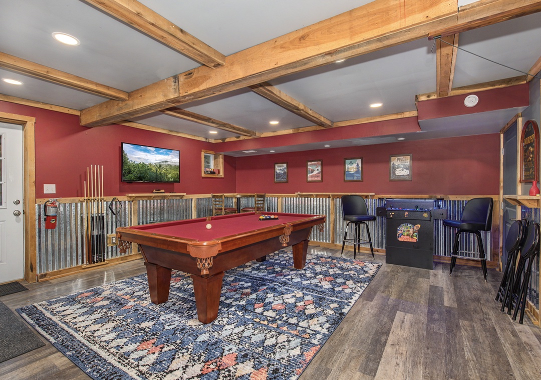 Challenge your group to a friendly game on the pool table or unwind at the bar in this rustic-chic game room with exposed beams and mountain charm.