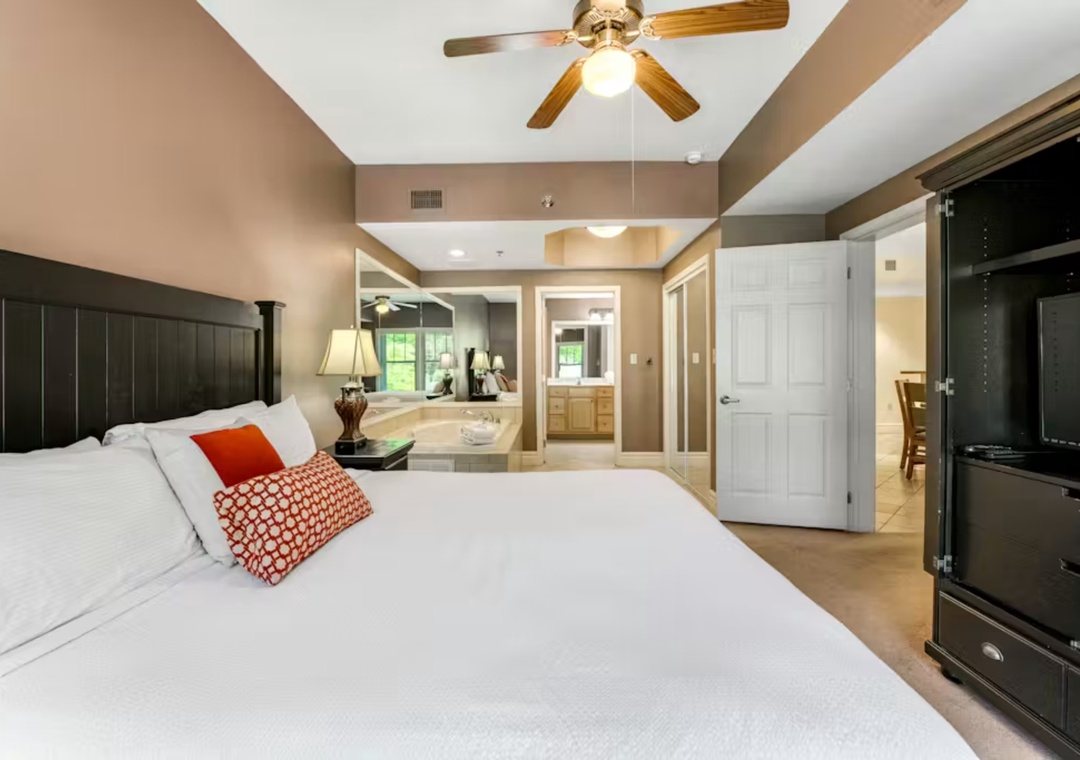 Your spacious master suite features plush bedding, a romantic soaking tub, and modern amenities for the perfect retreat.