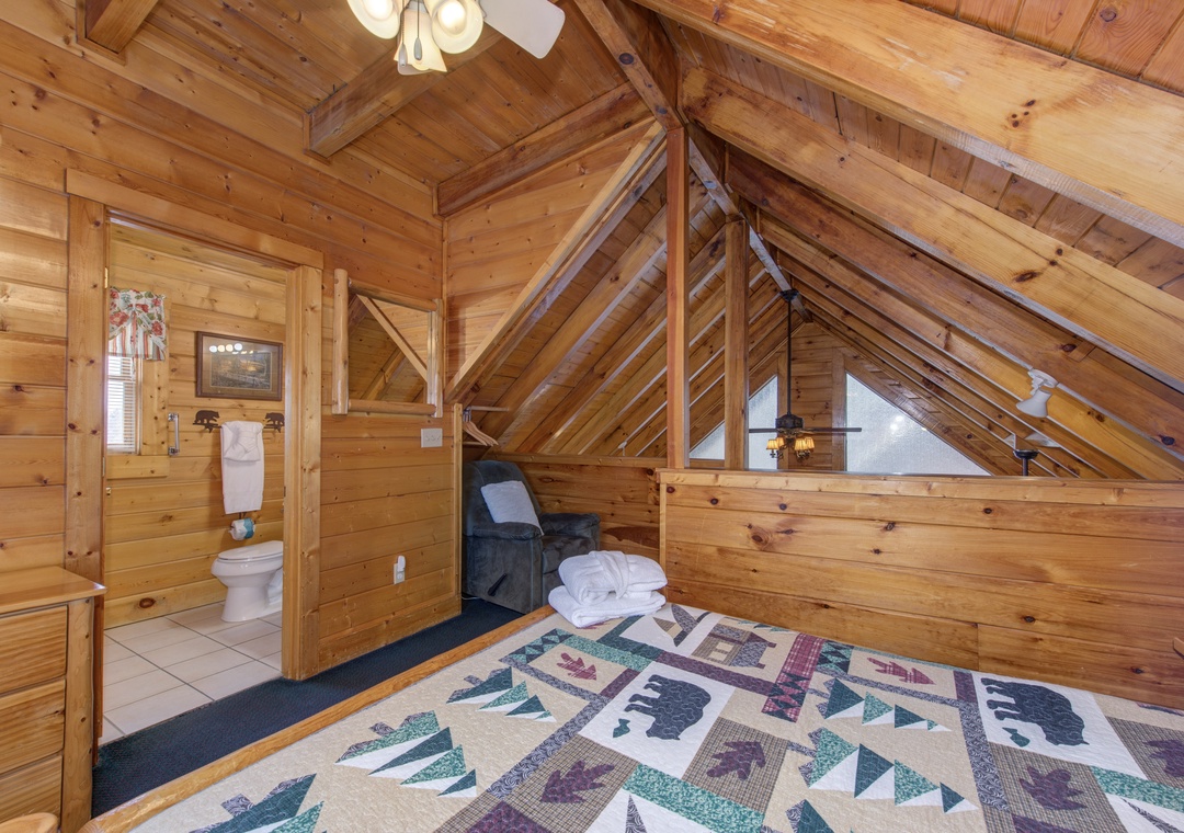 Cozy loft bedroom with rustic wood beams creates your perfect mountain retreat sanctuary.