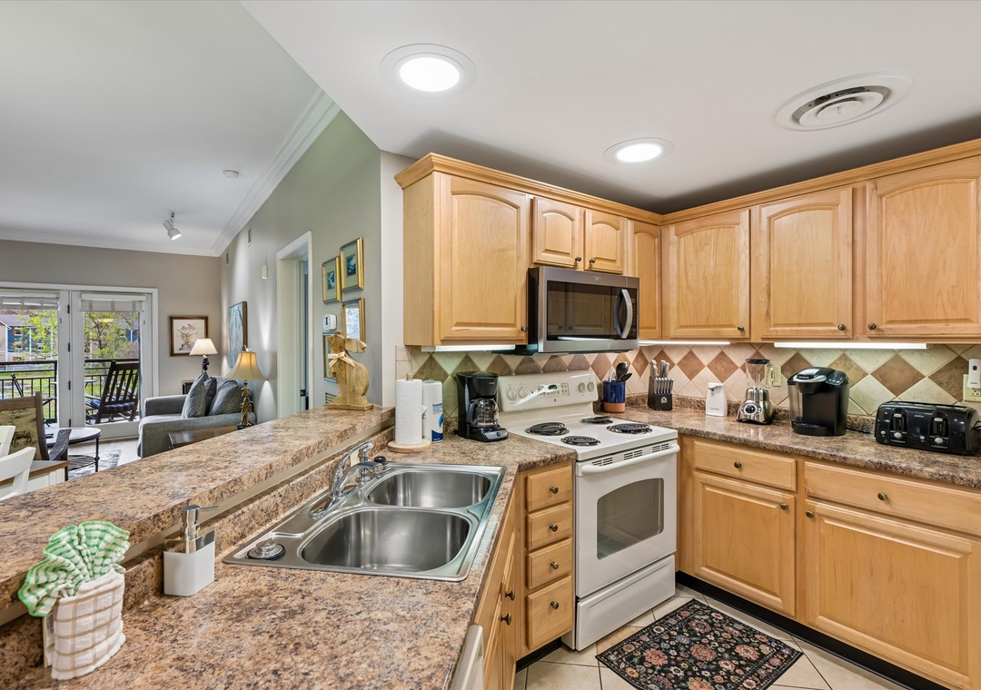 Your fully equipped kitchen features granite counters, wood cabinets, and everything needed for home-cooked meals during your stay.