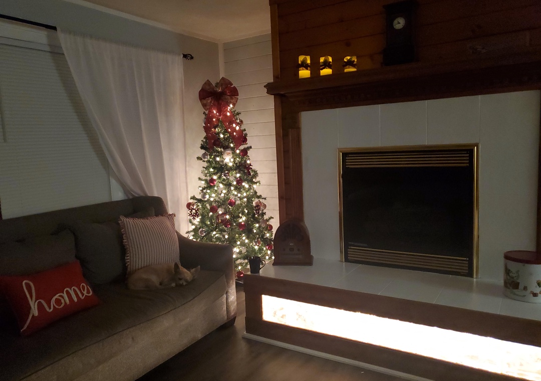 Cozy up by your fireplace where twinkling holiday lights create magical moments during your winter stay.