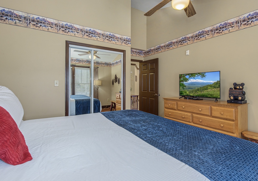 Sink into comfortable bedding while enjoying mountain views on the TV in this cozy room with rustic charm and thoughtful touches.