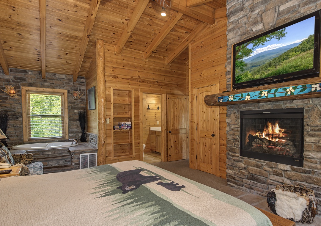 Unwind in your cozy bedroom with crackling fireplace, mountain views on TV, and a relaxing jetted tub nearby.