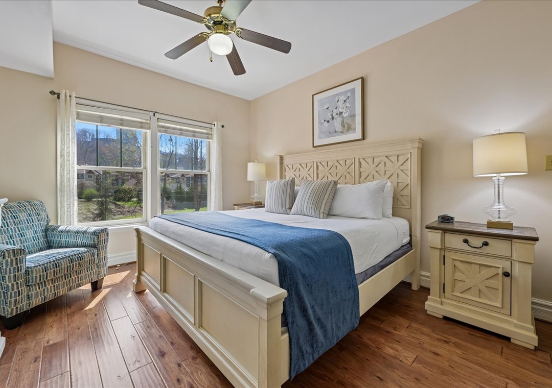 Drift off in your cozy retreat with crisp linens and a gentle ceiling fan breeze while natural light streams through.