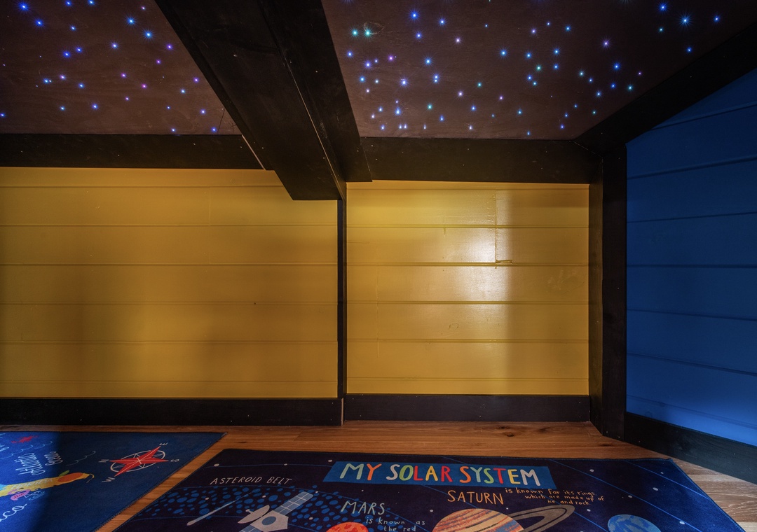 Your little ones will be amazed by this magical space room with twinkling star ceiling and colorful solar system floor.