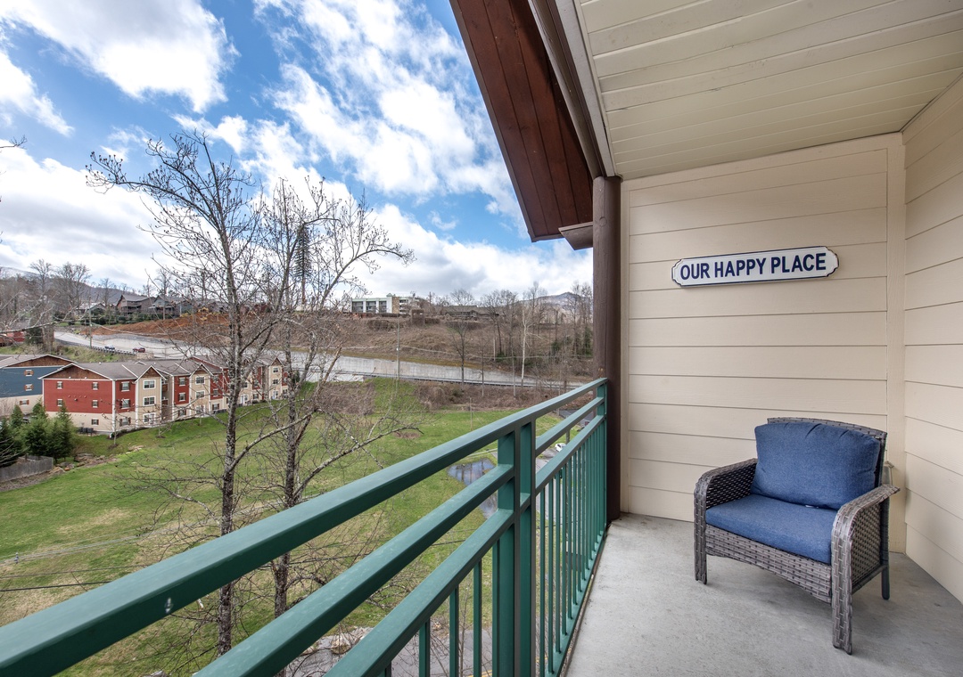 Step onto your private balcony where a cozy chair awaits, perfect for morning coffee while overlooking the peaceful neighborhood landscape.
