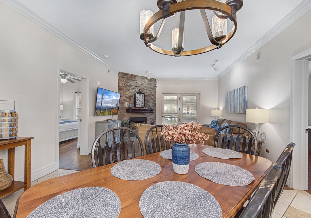 Gather around your elegant dining table for memorable meals, with the stone fireplace creating the perfect cozy backdrop.