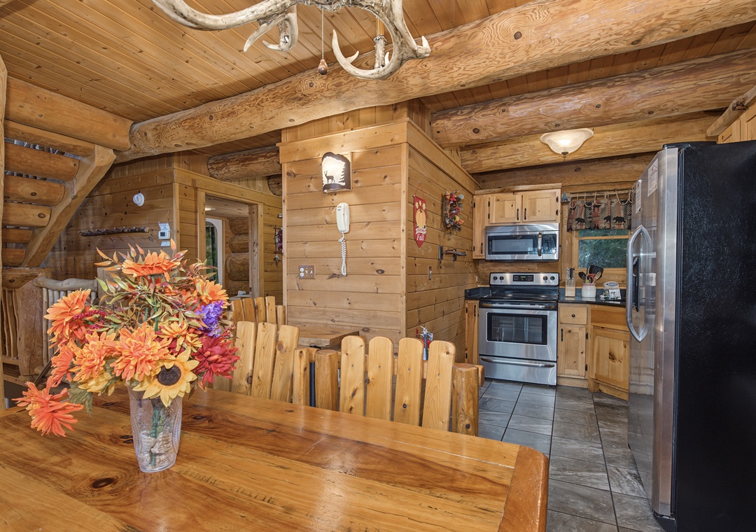 Gather around the rustic log table beneath dramatic antler chandeliers, where your group can share meals and stories in this authentic timber cabin setting with a fully-equipped kitchen at your service.