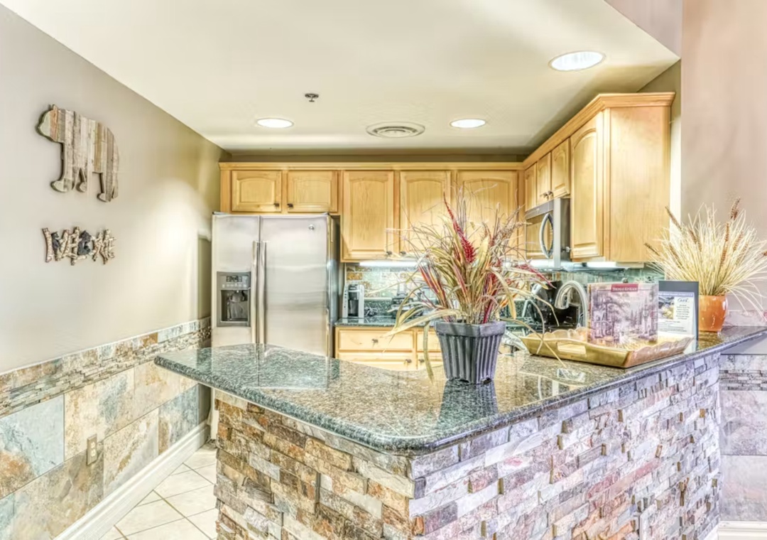 Your gourmet kitchen features granite countertops, stainless steel appliances, and a breakfast bar perfect for morning coffee or casual dining.