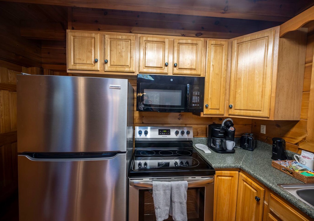 Your fully equipped kitchen features stainless steel appliances and rich wood cabinetry, perfect for preparing meals during your mountain getaway.