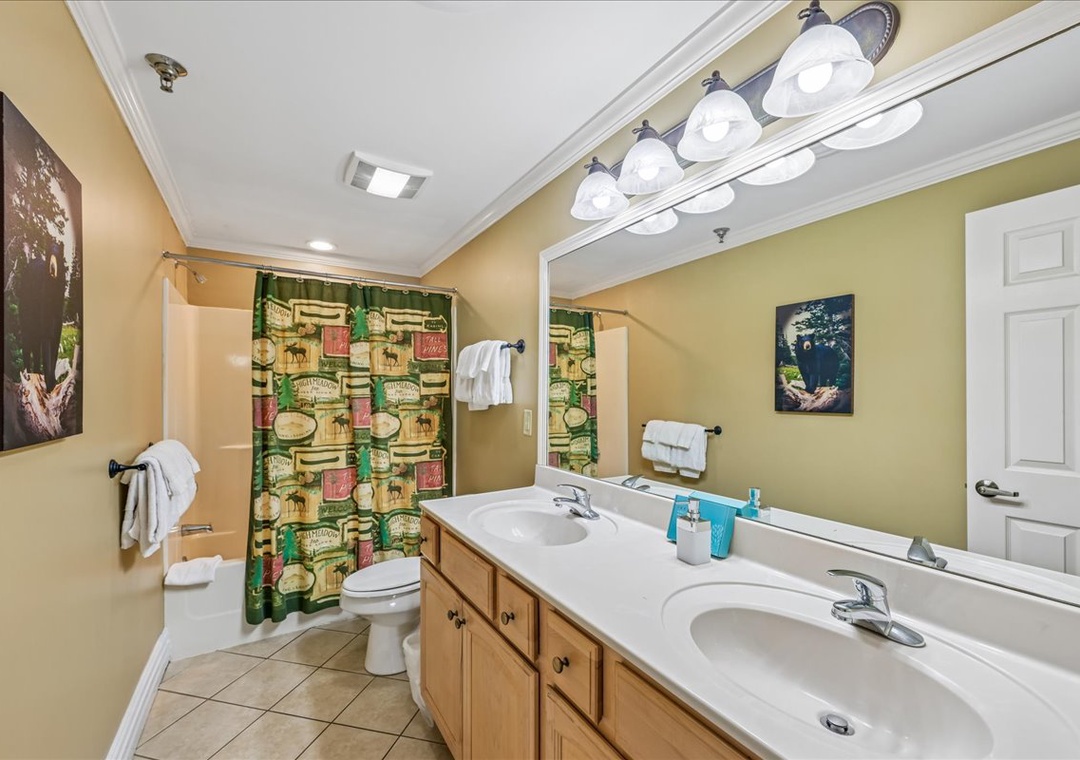 Refresh in your spacious bathroom with dual sinks, ample vanity space, and fresh towels waiting for you after a day of adventure.